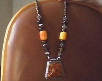 Amber necklace with orange colored stones.