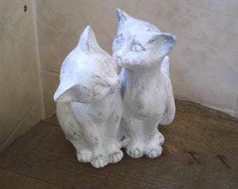two cats embraced white patina