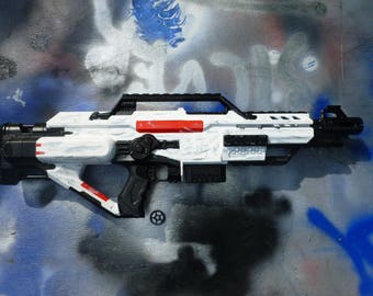 White and black nerf gun with distressed weathering