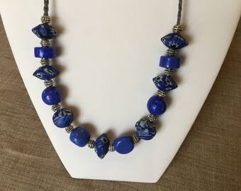Necklace glass beads and Blue ceramic on leather.
