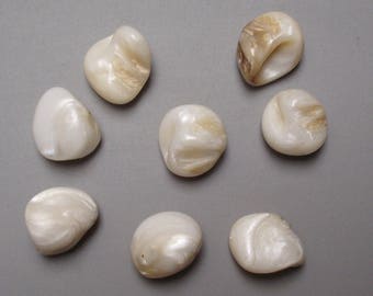 Set of 8 natural mother of pearl beads are drilled.