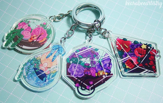 This listing is for a terrarium keychain based on the characters from Steven Universe!  Charms are clear acrylic with attached keyring. Theyre double sided and 2 inches long. Original artwork was created digitally.  There are 4 different designs: Steven, Pearl, Amethyst, or Garnet.