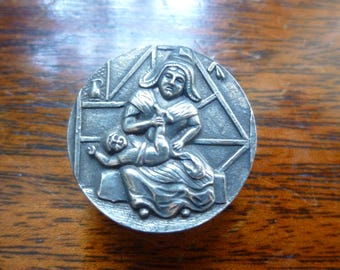 Button depicting mother and baby (late 1800's).