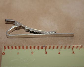 A silver metal tie clip