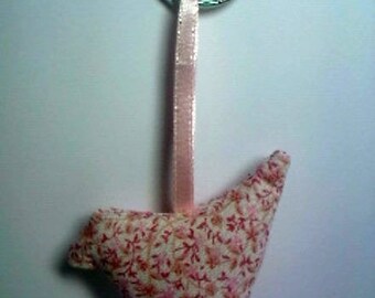 A little pink bird to a keychain. One pink