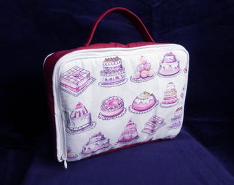 Pink padded suitcase printed cakes.