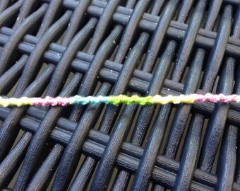A bracelet pale pink, pale yellow, green and blue