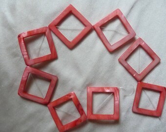 Beads, Mother of Pearl, 48mm Open Diamond, Shades of Coral. Sold per 15 inch strand. There are 8 beads on the strand.