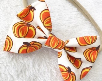 Pumpkin hair bow. Pumpkin bow. Candy corn pumpkin fabric. Halloween hair bow. Fall hair bow. Hair accessories. Nylon headbands. Pumpkins.