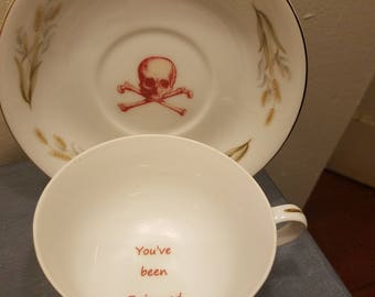 You've been poisoned tea cup and saucer