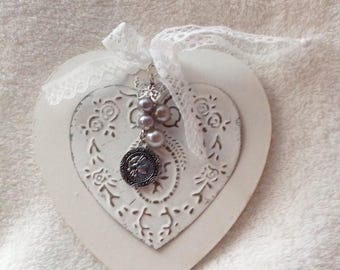 Placed on a wooden heart hammered metal heart