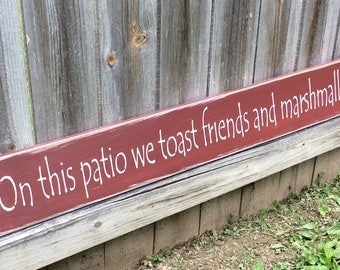 Handmade, Wooden, Long Sign. "On this Patio we toast friends and marshmallows". How warm and welcoming is this?. Family, Friends, Neighbors.