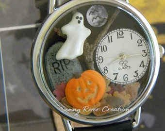 Spooky Halloween Watch with glow-in-the-dark pumpkin face and edge of ghost with autumn leaves tombstone moon bats and dead tree