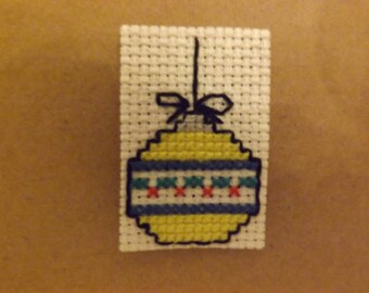 Yellow ornament embroidered on unbleached canvas