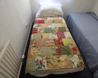 Patchwork quilt, lap quilt, sofa throw. Co-ordinating designer fabric samples randomly pieced. Tan, red, green. Handquilted. Plaid backing