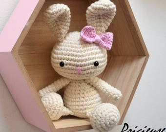 Amigurumi toy crocheted ecru with a bow pink