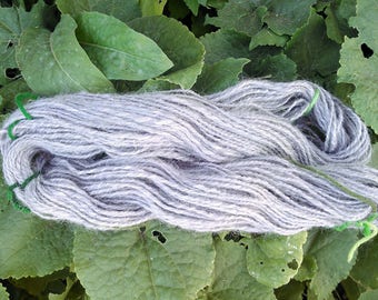 100% Alpaca Handspun Yarn 2 ply in very pale lavender/gray. Worsted weight (11 wpi), aprox 87 yards/ 3.4 ounces