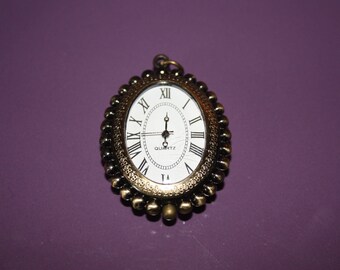 VERY NICE CLOCK PENDANT "AUDREY HEPBURN" BRONZE