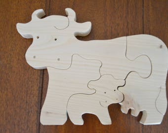 4 piece puzzle of a cow with her calf in tree