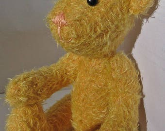 Adorable teddy bear in golden yellow fur