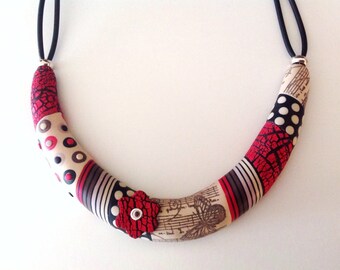 Red, black and white polymer torque necklace off