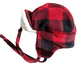 Buffalo plaid trapper hat for toddler with cream colored sherpa lining. Fits up to 18" around.