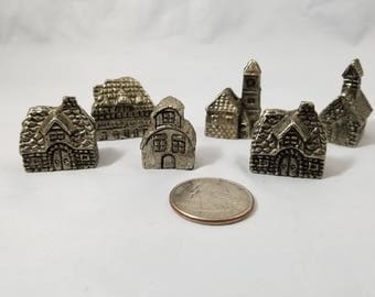 A Set of 6 Miniature Pewter Village with Church and Houses.