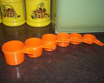 Vintage Tupperware Measuring cups in brilliant orange in really great condition