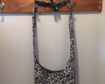 Black & White Reversible Cross Body Bag with Adjustable Strap and Pocket.
