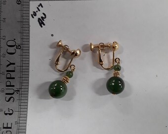 Gold toned screw back earrings green beads