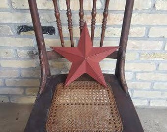 Antique wooden dining chair with pressed cane and spindle back