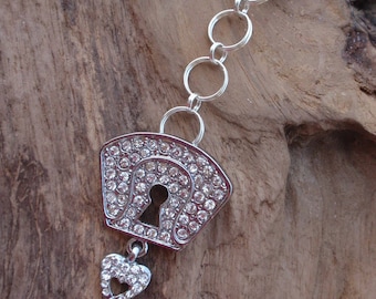 Worn silver metal key and rhinestone. Key lock and key