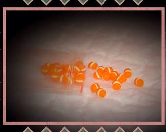 Mini transparent Orange macaroon and his slice of vanilla