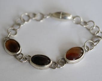 Silver bracelet with mounted stones