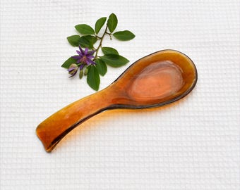 Fused glass spoon rest or dish in transparent amber with a feathery pattern