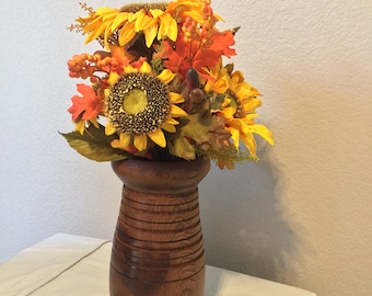 Hand turned vase with arrangement.
