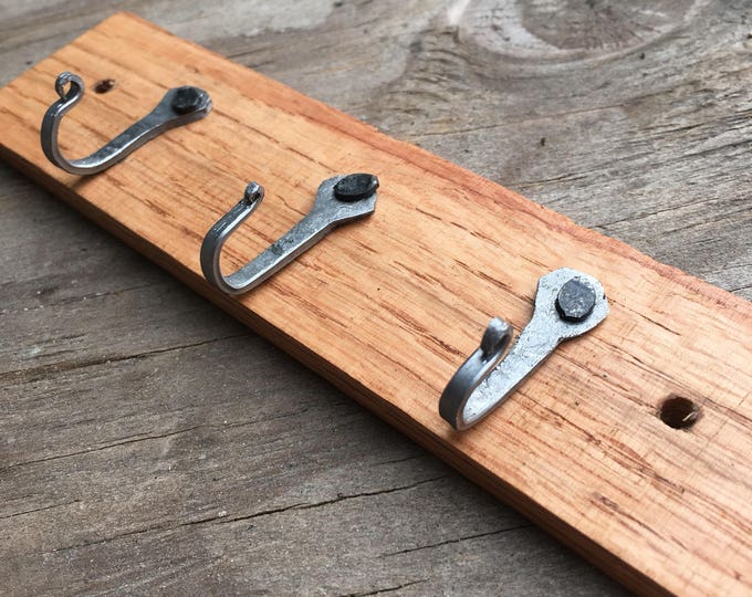 Small key rack with horseshoe nail hooks