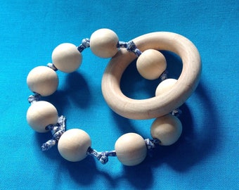Wooden rattle and teether in her pouch.