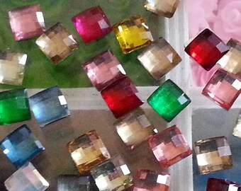 Perhaps 50 resin cabochons, including some people matte, faceted, square, mixed color, 6 x 6 x 2 mm