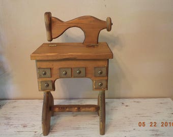 Vintage wooden treadle sewing machine with small storage area decoration / sewing storage