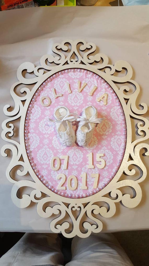 Baby shoe keepsake on fabric in pearl color painted wood frame