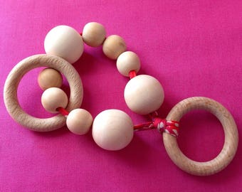 Wooden rattle and teether in her pouch.