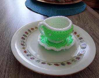 Cup and saucer with hand made crochet