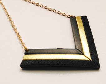 black leather and gold necklace