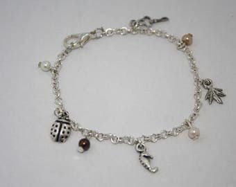 Bracelet chain with various charms and pearls