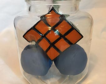 3x3 Rubiks cube and racquetballs in a jar without lid