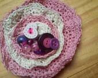 Brooches made in pink cotton and ecru crochet and beads and assorted buttons