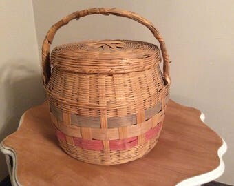 A vintage large wicker picnic basket with lid