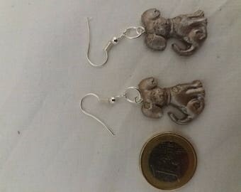 Silver resin earrings depicting a dog.