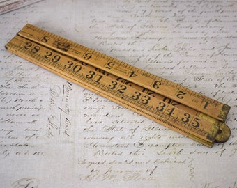 Vintage wooden folding ruler or measuring stick, yardstick